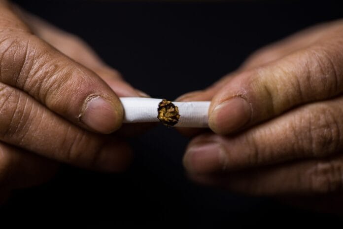 Closeup shot of a cigarette cut in half-quitting smoking concept
